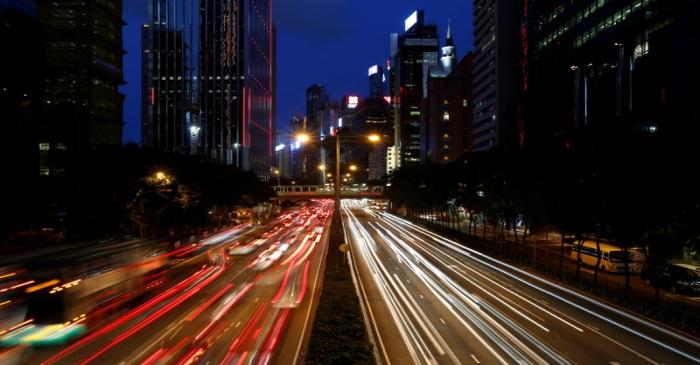 Traffic is seen between office buildings in downtown Hong Kong