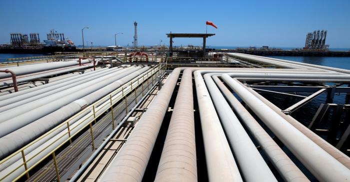 An oil tanker is being loaded at Saudi Aramco's Ras Tanura oil refinery and oil terminal in