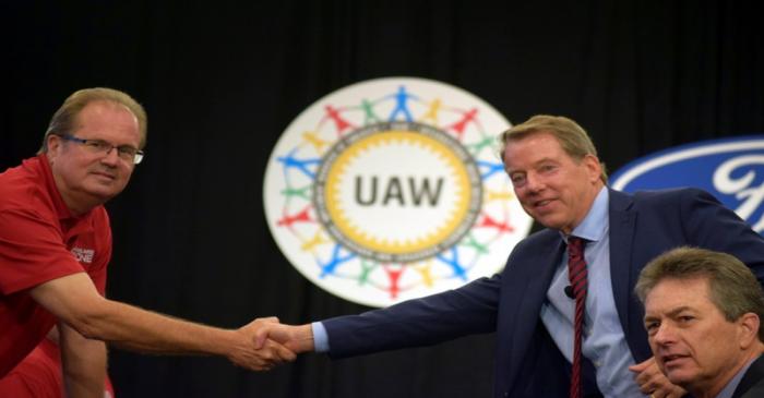FILE PHOTO: UAW President Gary Jones shakes hands with Ford Motor Co Chairman Bill Ford at the