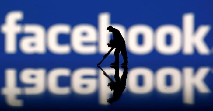 FILE PHOTO: A figurine is seen in front of the Facebook logo in this illustration