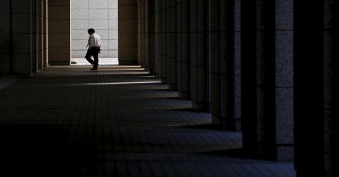 A businessman walks at a business building in Tokyo