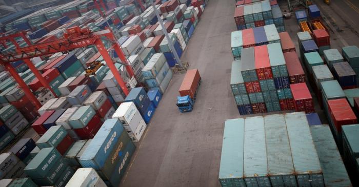 FILE PHOTO: A truck drives between shipping containers at a container terminal at Incheon port