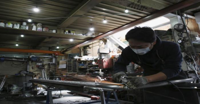 An engineer makes an arm rail for residential buildings inside a metal processing factory at an