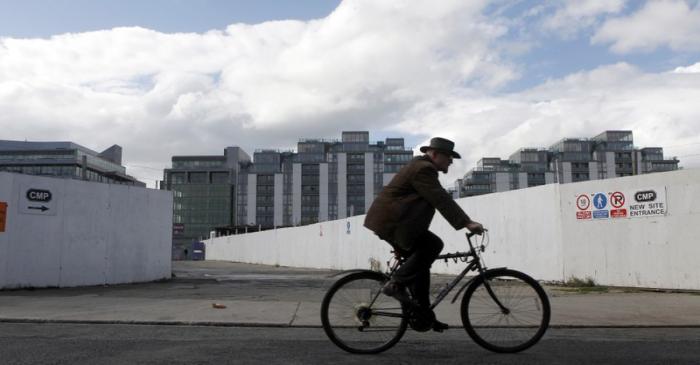 A cyclist makes his way past empty and unfinished building projects in the Quays area of Dublin