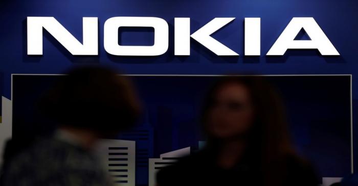 FILE PHOTO: Visitors gather outside the Nokia booth at the Mobile World Congress in Barcelona
