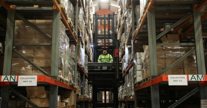 An employee operates a forklift to move goods at the Miniclipper Logistics warehouse in