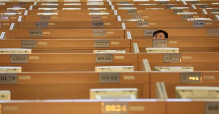 A trader sits on the trading floor at the Shanghai Stock Exchange in Lujiazui Financial Area