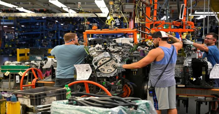 FILE PHOTO: Engines arrive on the assembly line at the General Motors (GM) manufacturing plant