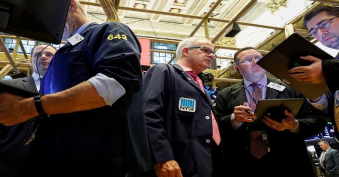 Traders work on the floor at the NYSE in New York