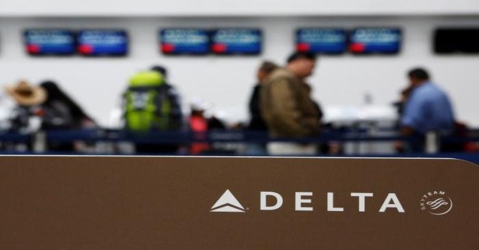 FILE PHOTO: Passengers check in at a counter of Delta Air Lines in Mexico City
