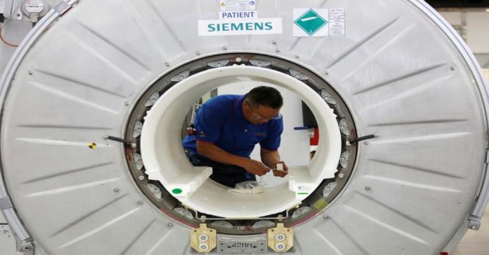 FILE PHOTO: A staffer works on a magnetic resonance imaging machine at a production line of