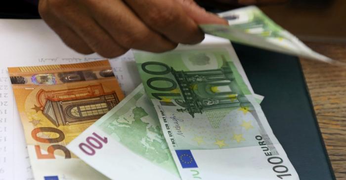 An employee counts Euro bills at a money exchange office in central Cairo