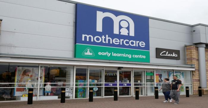 People walk past a Mothercare store in Altricham