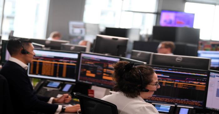 Traders are seen at work at Northern Trust offices in London