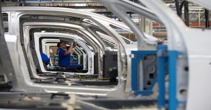 An employee works on the automobile assembly line of Bluecar electric city cars at Renault car