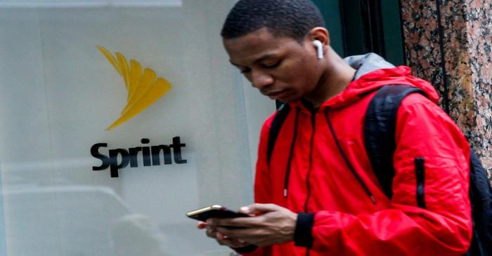 FILE PHOTO: A man walks past a Sprint store in New York