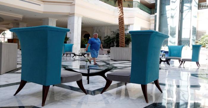 A Russian tourist walks in the lobby of the Steigenberger Kantaoui Bay Hotel, previously