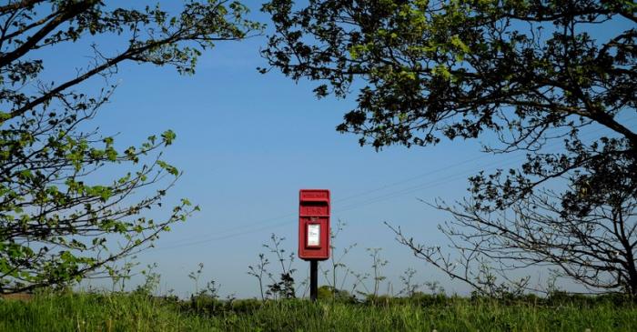 FILE PHOTO: A Royal Mail post box stands on the edge of a field near Lymm, northern England.