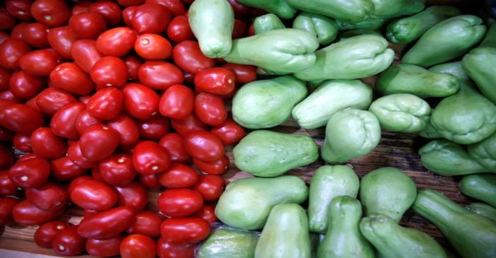 Tomatoes and chayotes are pictured at a groceries stall at a market in Mexico City