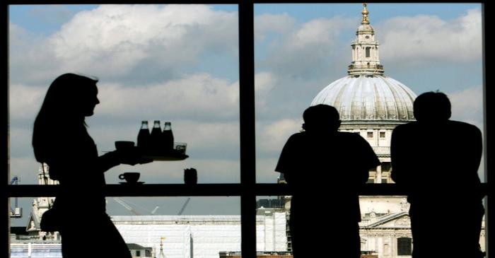 Visitors admire St. Paul's Cathedral from the restaurant floor of the Tate Modern gallery in