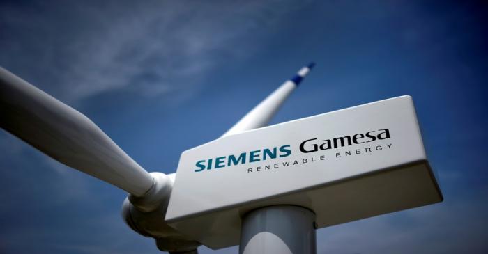 FILE PHOTO: A model of a wind turbine with the Siemens Gamesa logo is displayed outside the