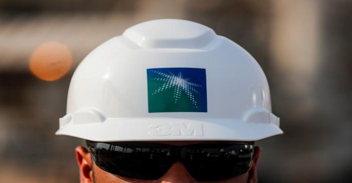 FILE PHOTO: An employee in a branded helmet is pictured at Saudi Aramco oil facility in Abqaiq