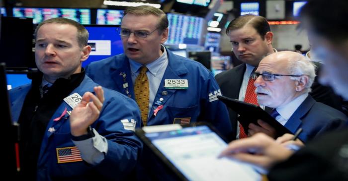 Traders work on the floor at the NYSE in New York