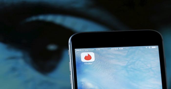 FILE PHOTO: Photo illustration of dating app Tinder shown on an Apple iPhone