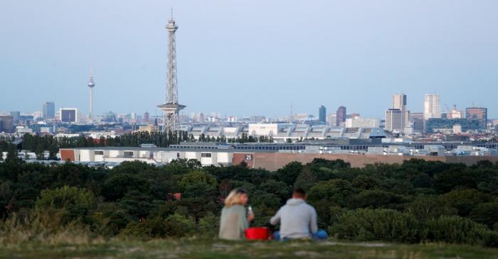 The city's skyline is pictured with the TV tower and radio tower during the early evening in