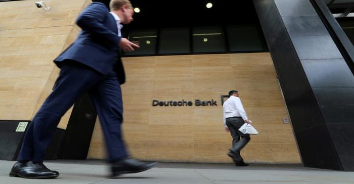 FILE PHOTO: People walk past a Deutsche Bank office in London