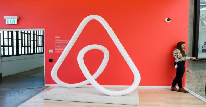 A woman talks on the phone at the Airbnb office headquarters in the SOMA district of San