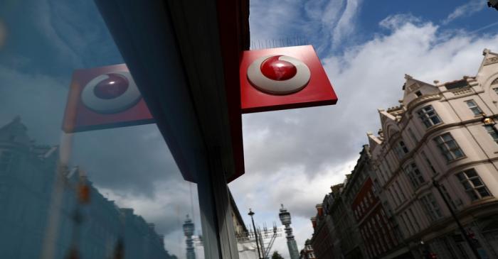A branded sign is displayed on a Vodafone  store in London