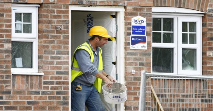A builder works at a Bovis homes housing development near Bolton