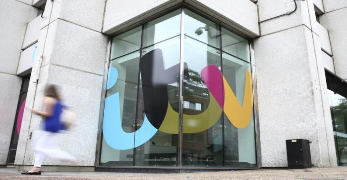 File photo of a company sign displayed outside an ITV studio in London