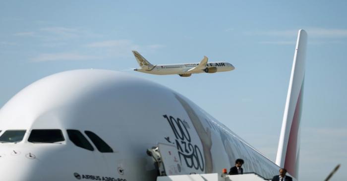 Gulf Air Boeing 787 aircraft makes a fly-by as Emirates Airlines Airbus A380 plane is seen