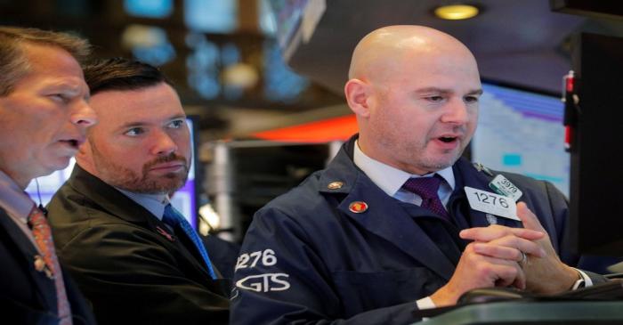 Traders work on the floor at the NYSE in New York