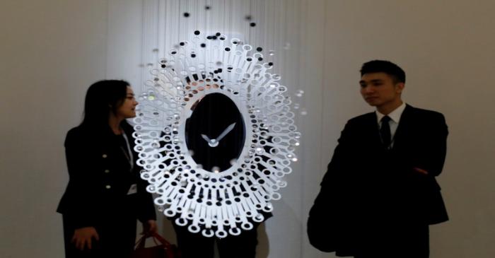 FILE PHOTO: Visitors are pictured in the Cartier at the SIHH watch fair in Geneva