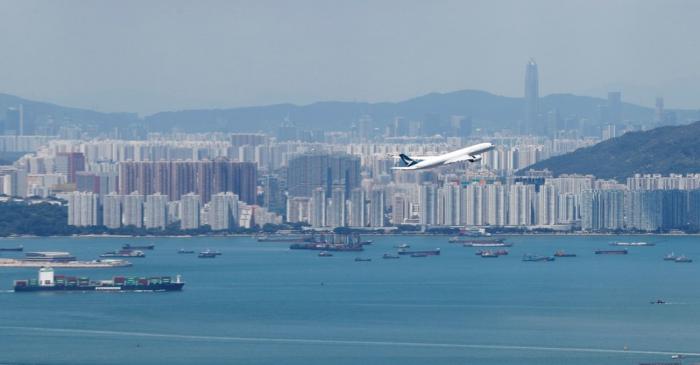 A Cathay Pacific flight flies over the city of Hong Kong