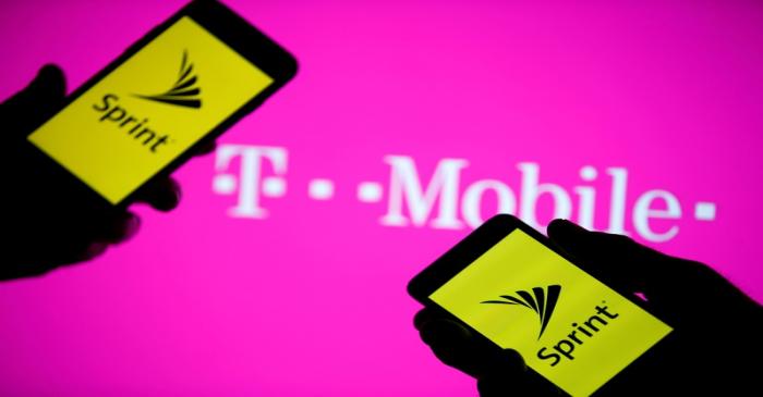 FILE PHOTO: A smartphones with Sprint logo are seen in front of a screen projection of T-mobile