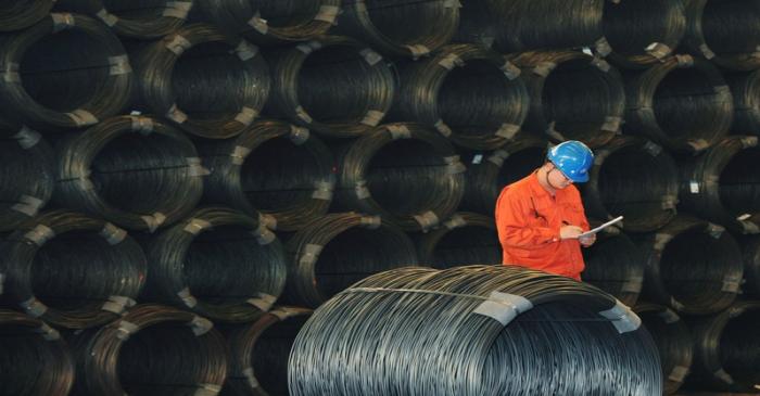 Employee works next to steel wires at a Dongbei Special Steel plant in Dalian