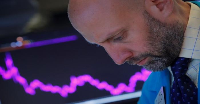 Traders work on the floor at the NYSE in New York