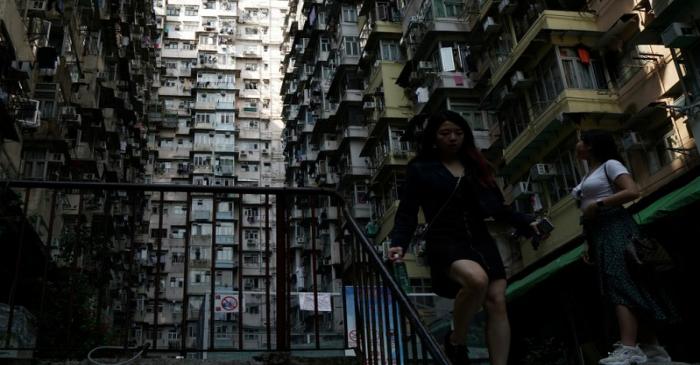 FILE PHOTO: Woman walks down the stairs of a residential building in Hong Kong