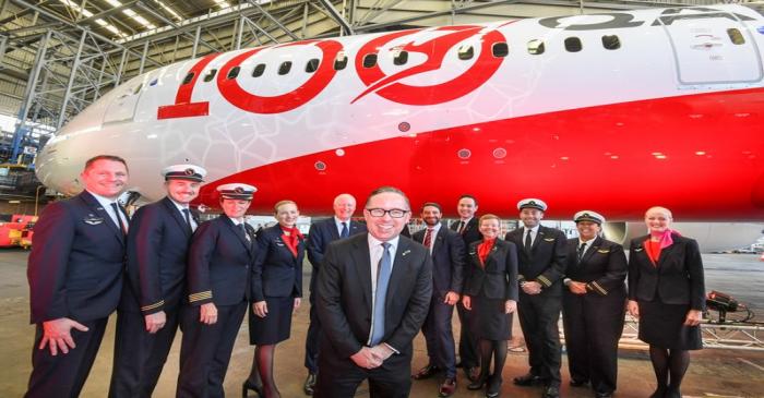 Qantas CEO Alan Joyce (centre) poses with the crew of QF7879, which flew direct from London to
