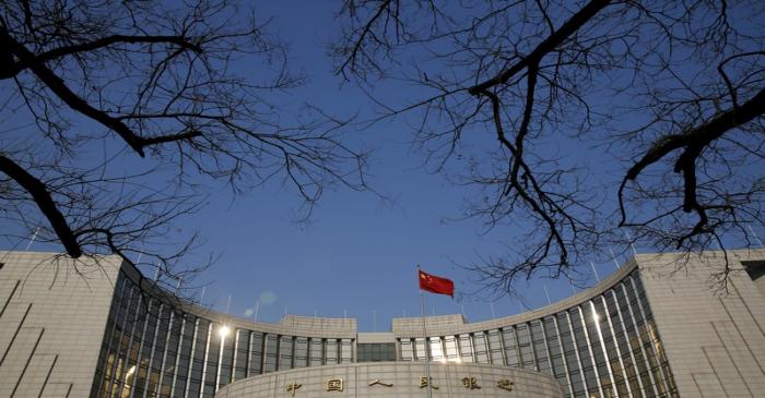 FILE PHOTO: A Chinese national flag flies at the headquarters of the People's Bank of China,