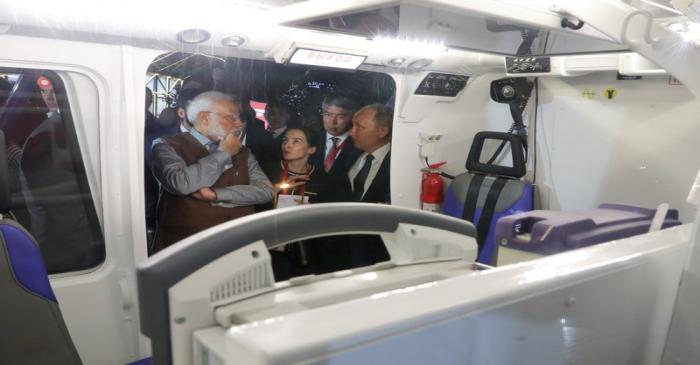 Russian President Putin and Indian Prime Minister Modi inspect a helicopter on the sidelines of