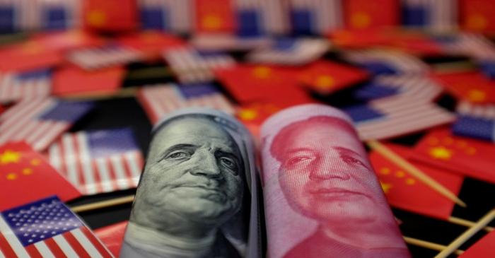 Illustration picture showing U.S. dollar and China's yuan banknotes