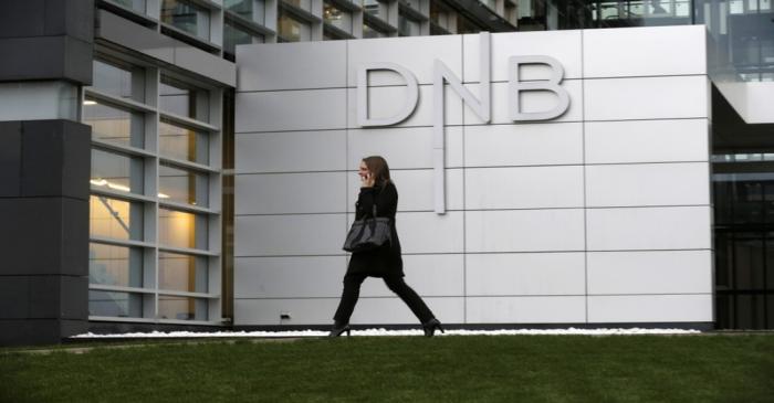 A woman walks past DNB bank's local office in Riga