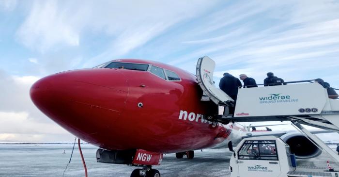 FILE PHOTO: Passengers board a Norwegian Air plane in Kirkenes