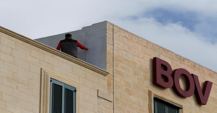 FILE PHOTO: A maintenance worker carries out repairs on the roof of a branch of Bank of