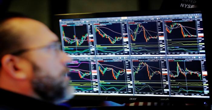 A trader works on the floor of the New York Stock Exchange shortly after the opening bell in